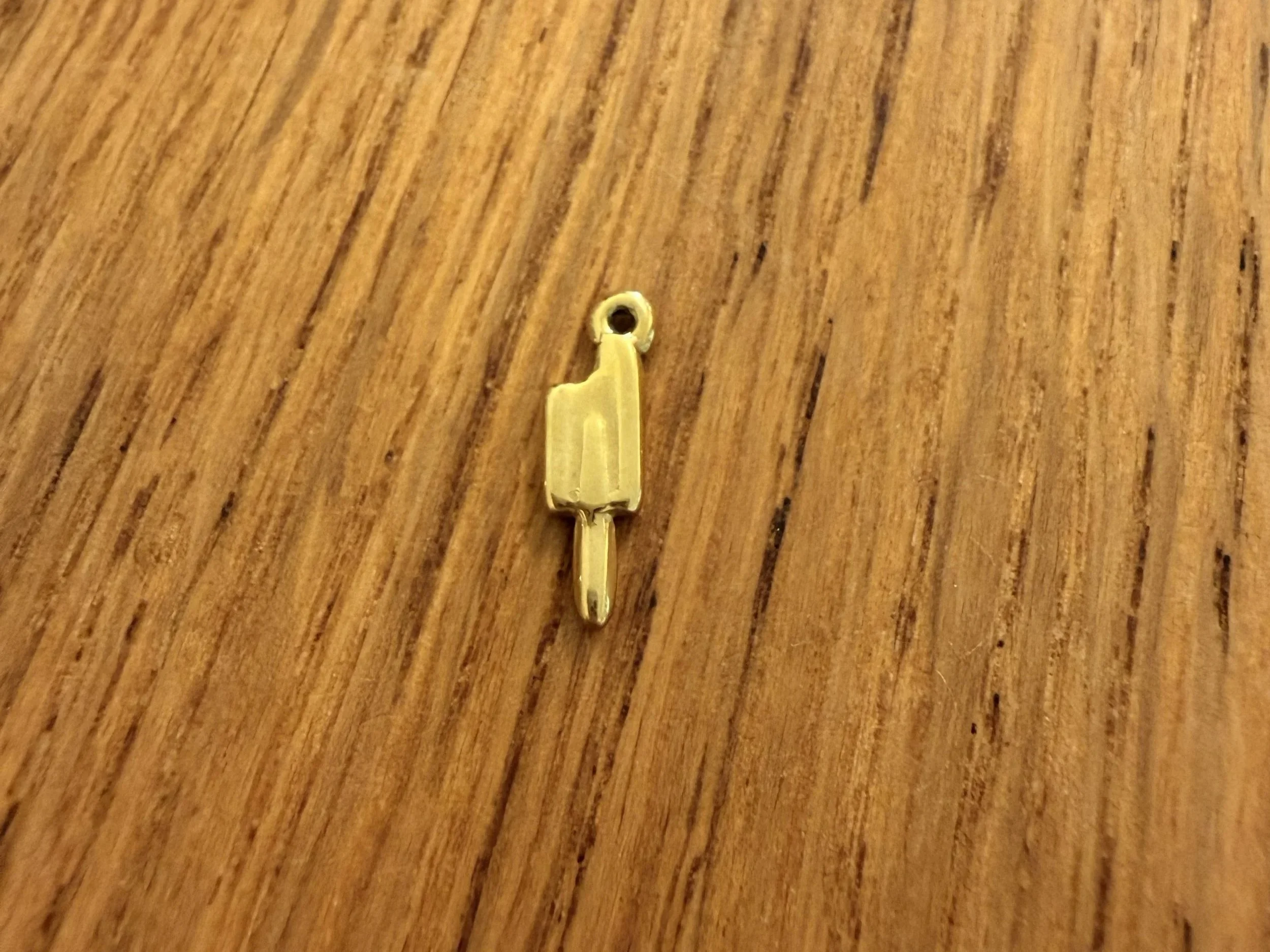 Close-up of Popsicle Charm by House of Azelea on wood countertop
