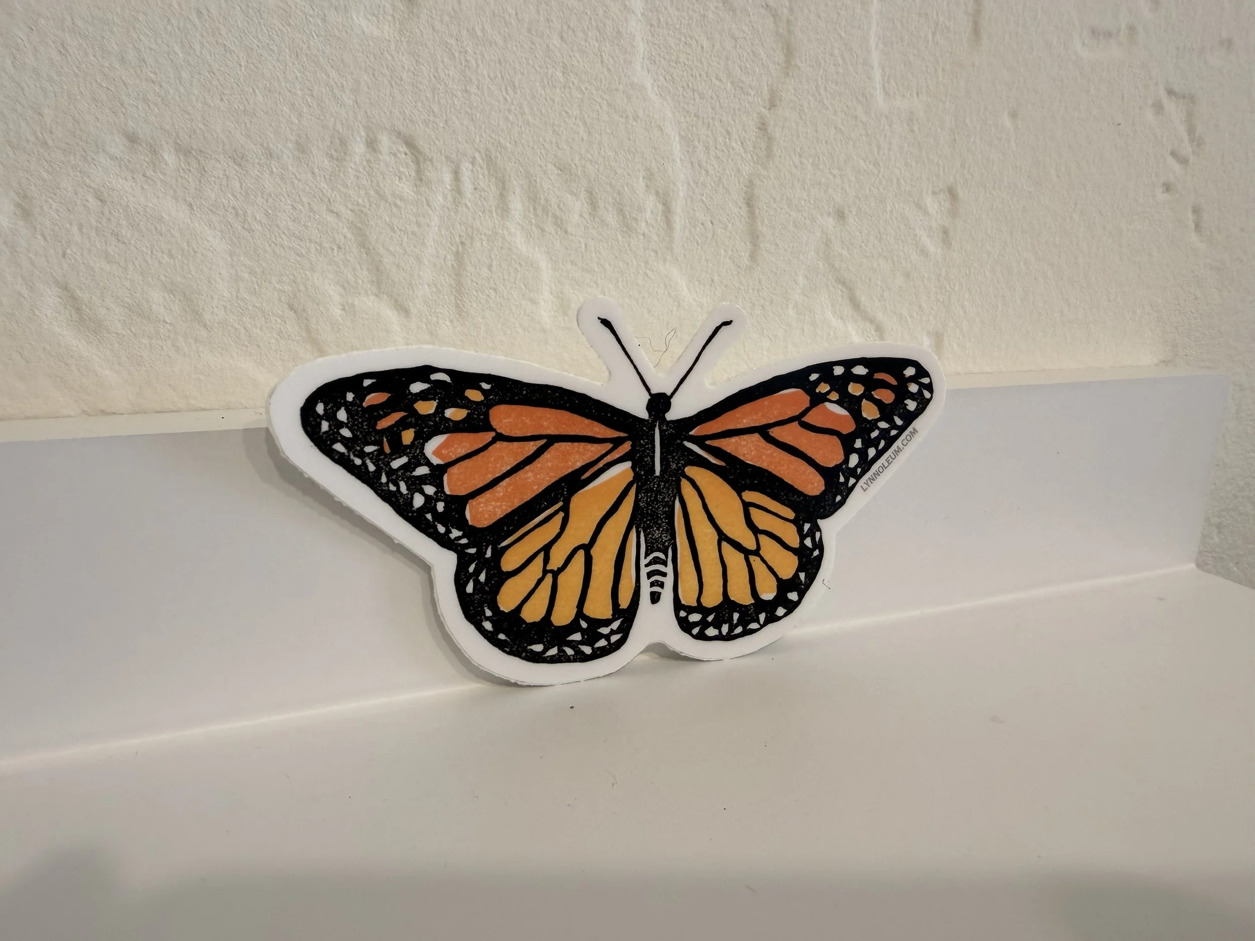 Monarch Butterfly Vinyl Sticker on white shelf