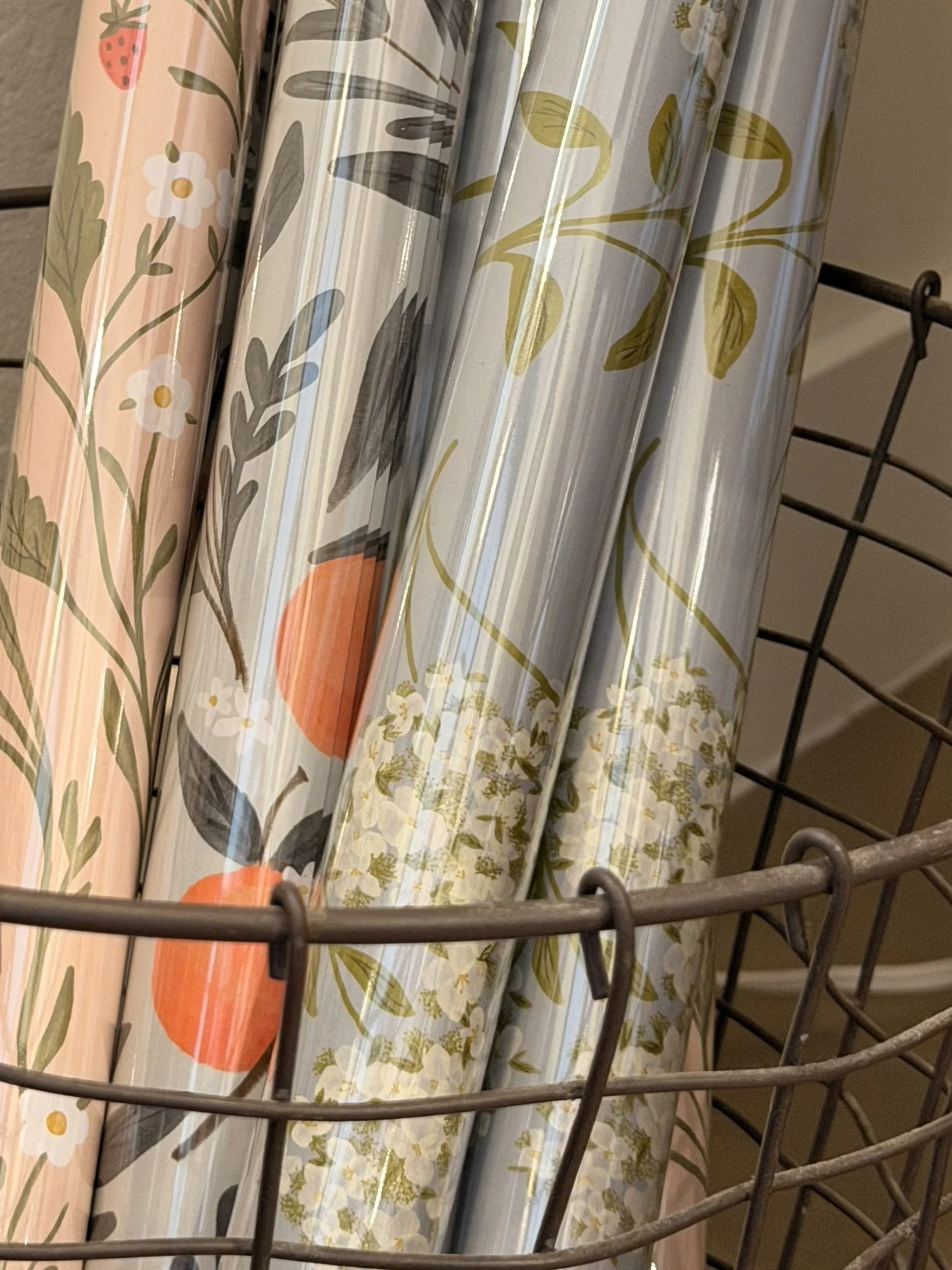 Close-up of Ramona & Ruth's wrapping paper at Bloomie's Boutique. Styles shown include (l-r) Strawberry Fields, Orange Vine, and Hydrangeas. (Photo credit: Melissa Mitchell-Hooge)