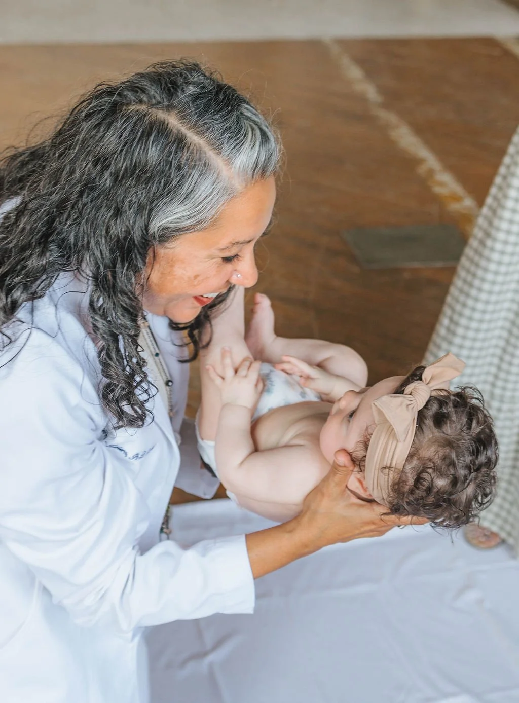 Lactation consultant assessing infant during Lactation appointment.