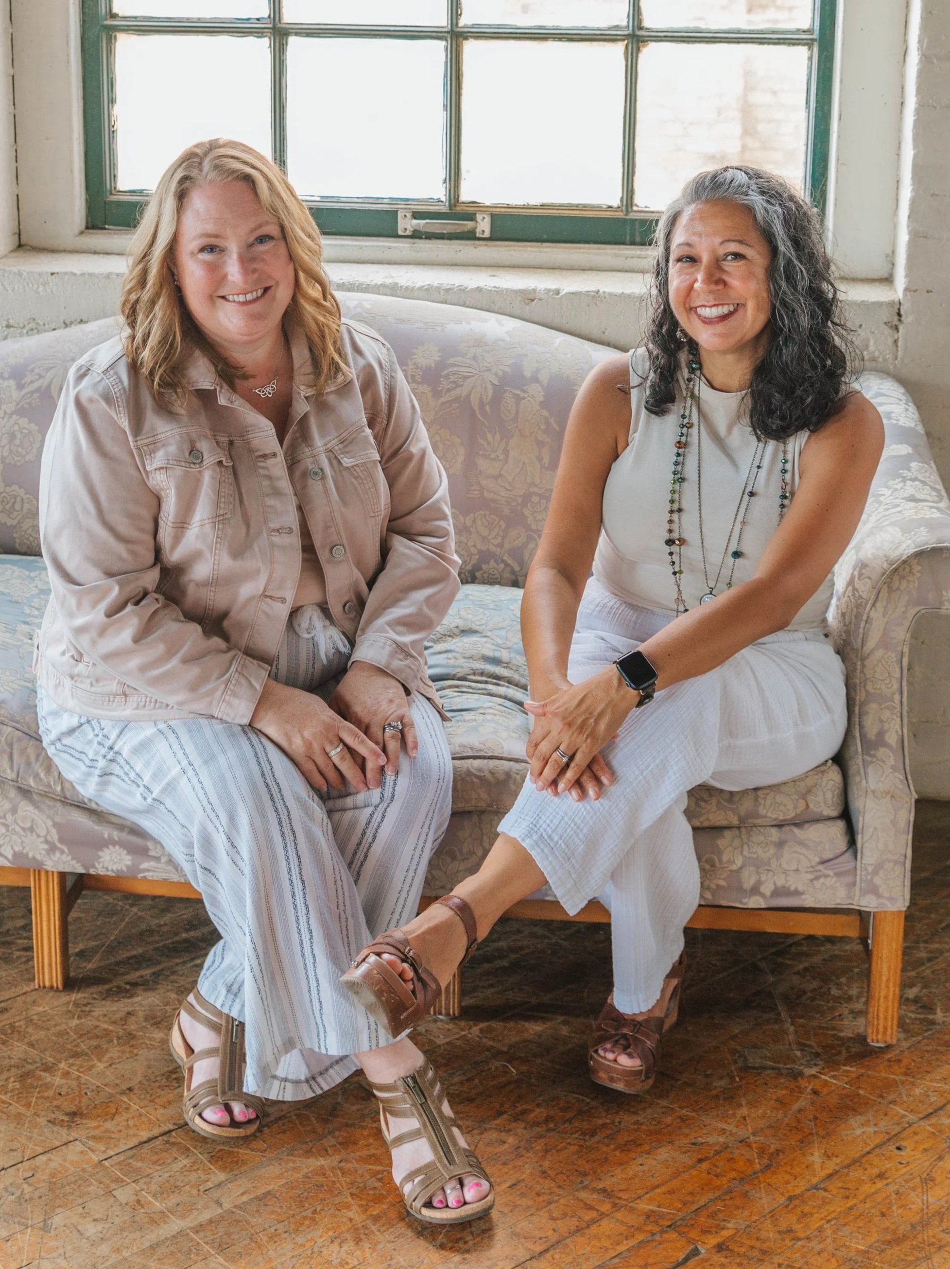 Lactation Co-Founders sitting together on a couch smiling
