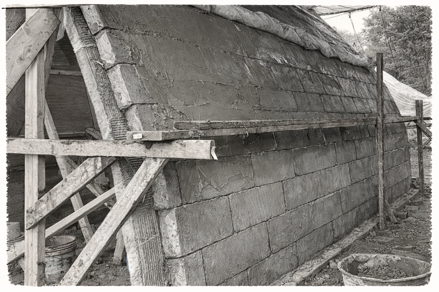 Laying bricks from the ground up.