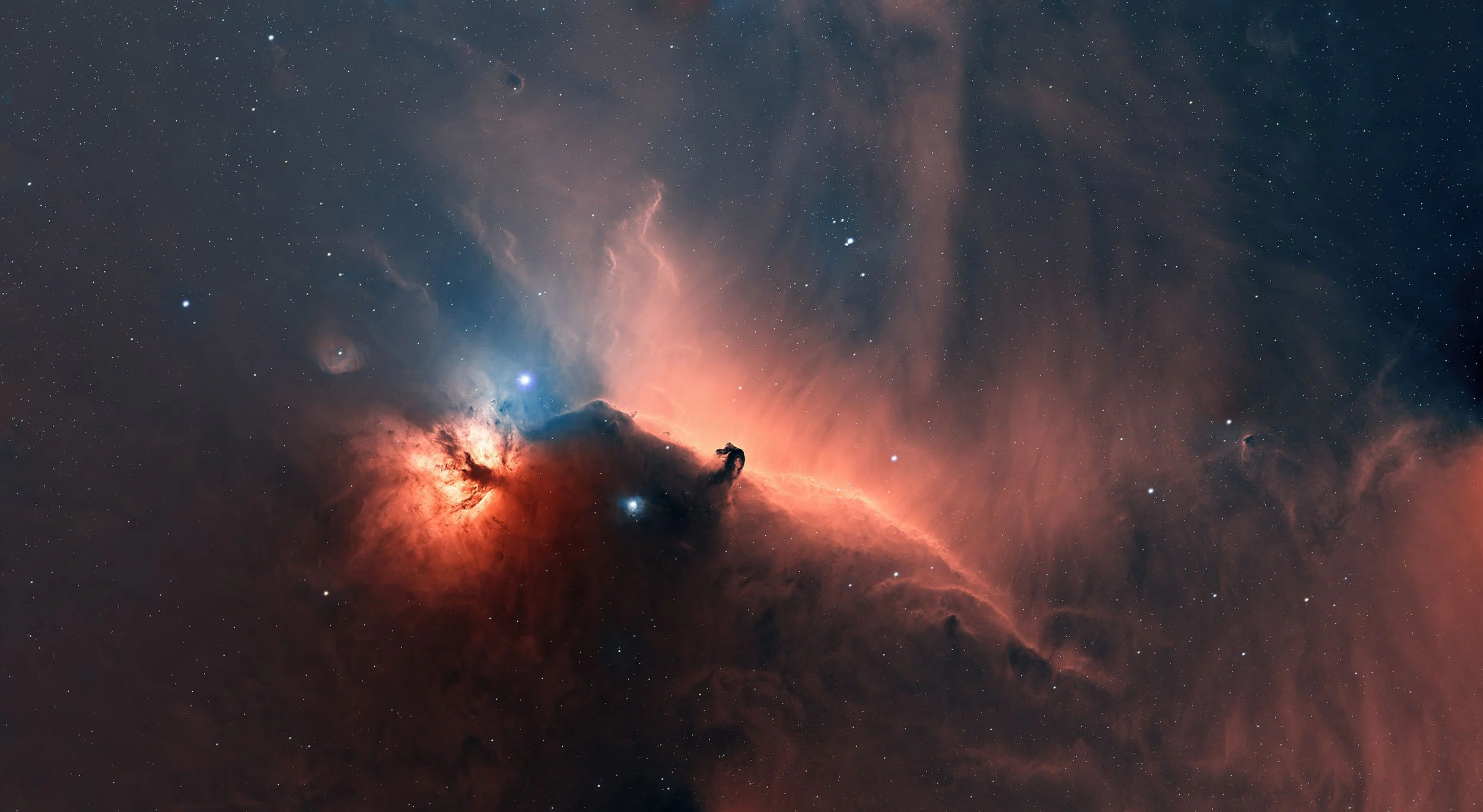 A detailed image of a nebula in space, showing glowing gas clouds, bright stars, and dark dust lanes with pink, blue, and black hues.