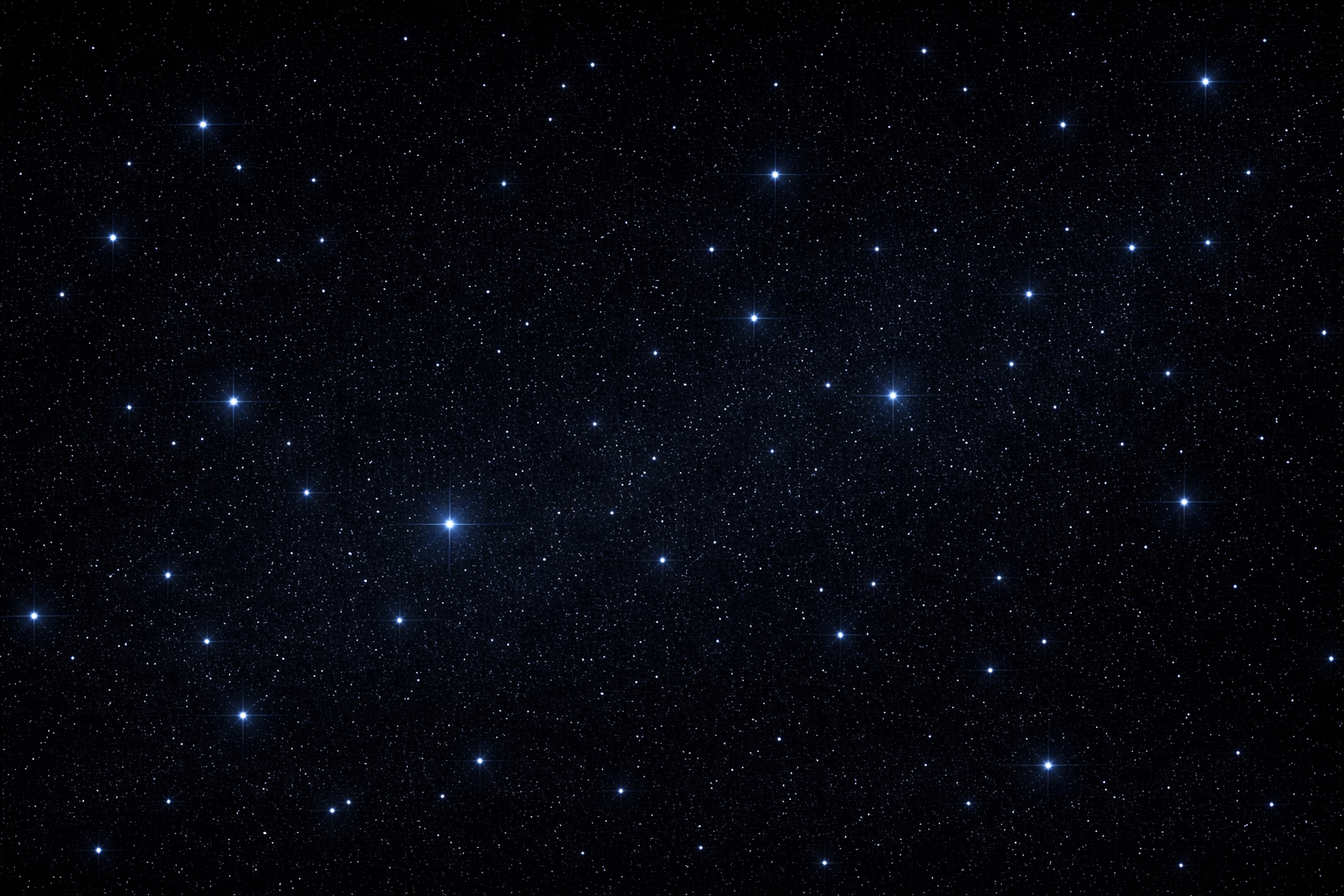 A starry night sky filled with numerous stars of varying brightness across the black background.