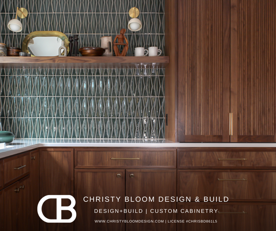 Custom wooden cabinetry and open shelving in a kitchen, with decorative items and a patterned tile backsplash.