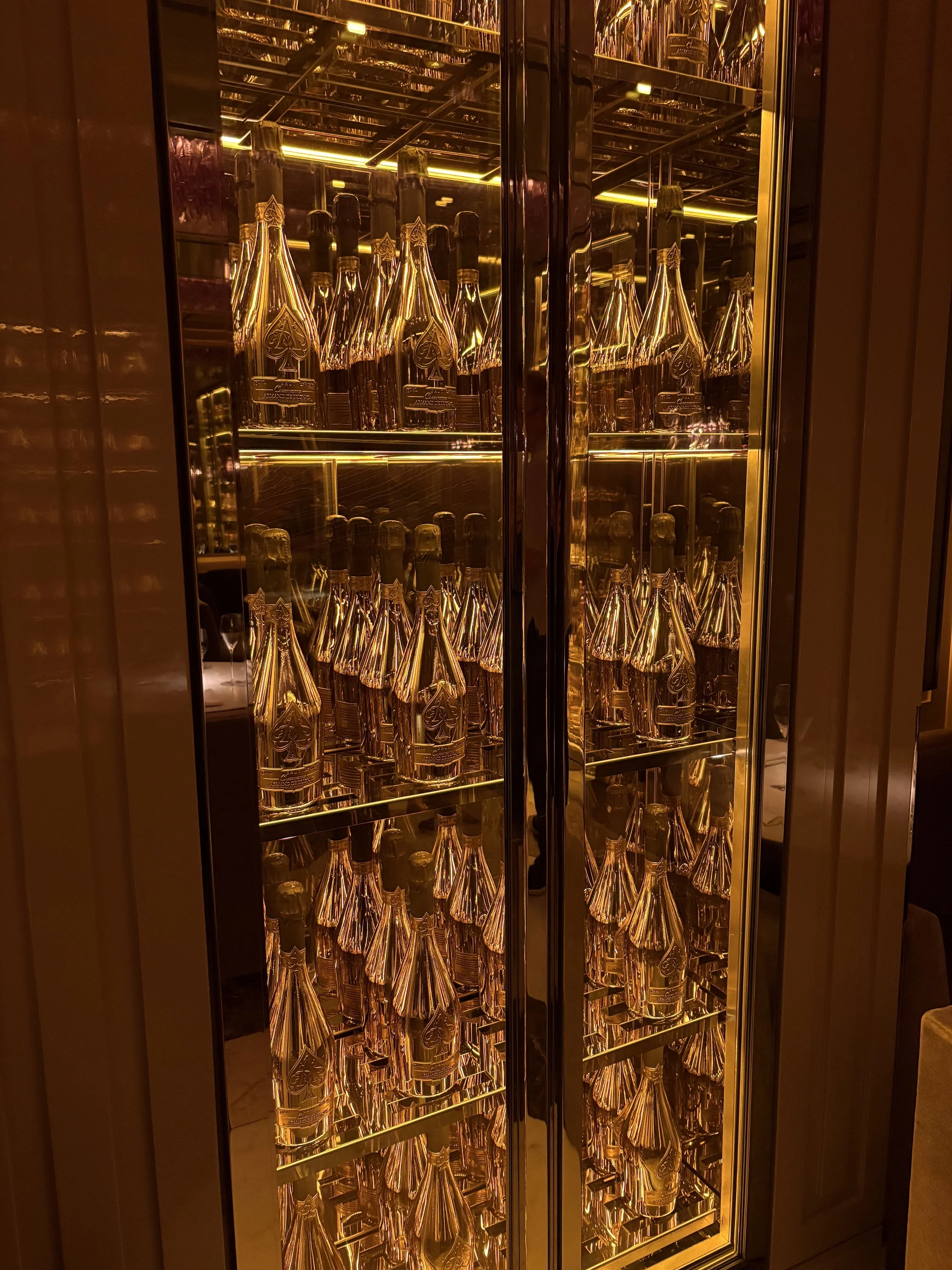 Underground champagne bar with multiple custom reach in cabinets optimized for champagne temperatures.