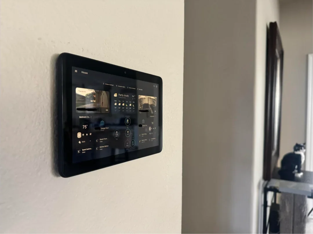 A smart home control panel mounted on a wall.