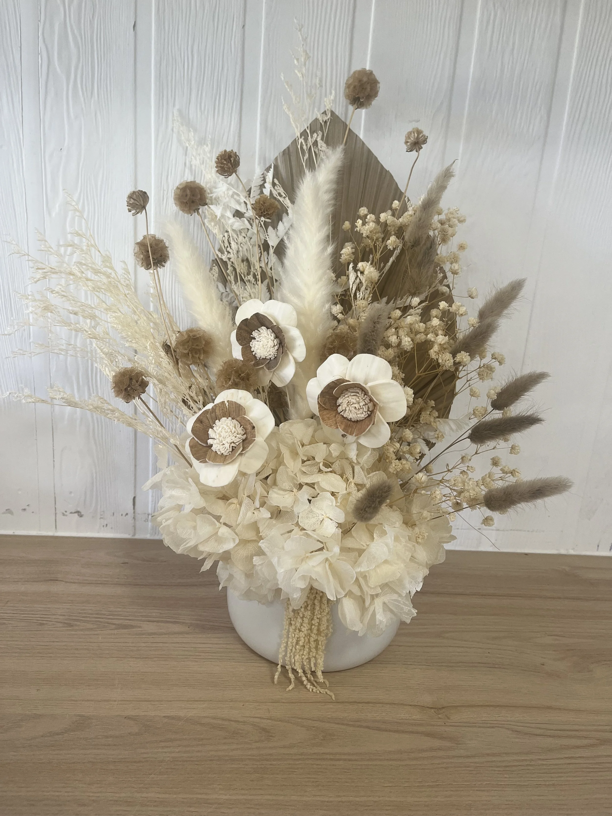 Close-up of a preserved floral arrangement featuring natural textures and soft colours.
