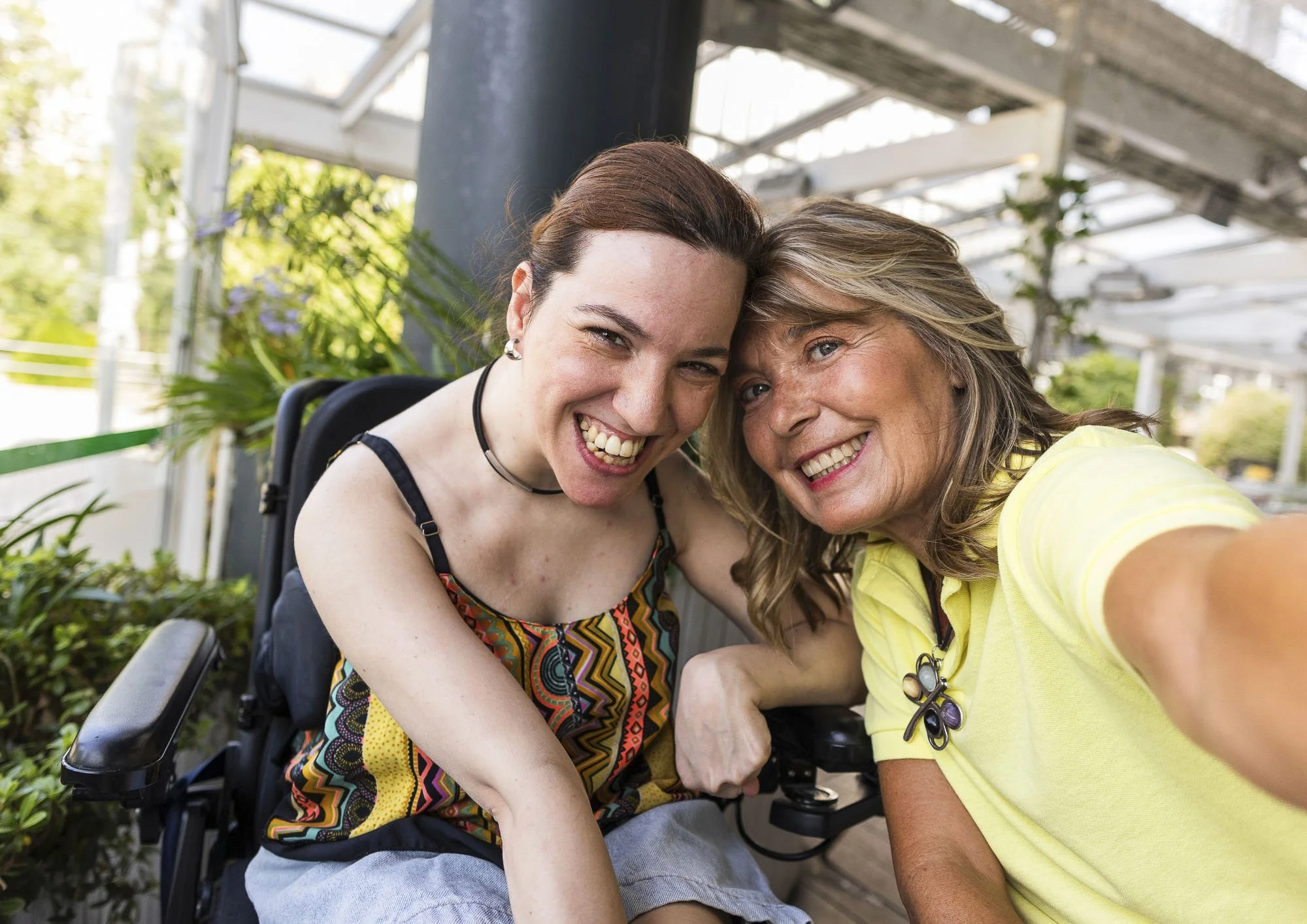 Two women celebrating friendship, confidence and community participation.