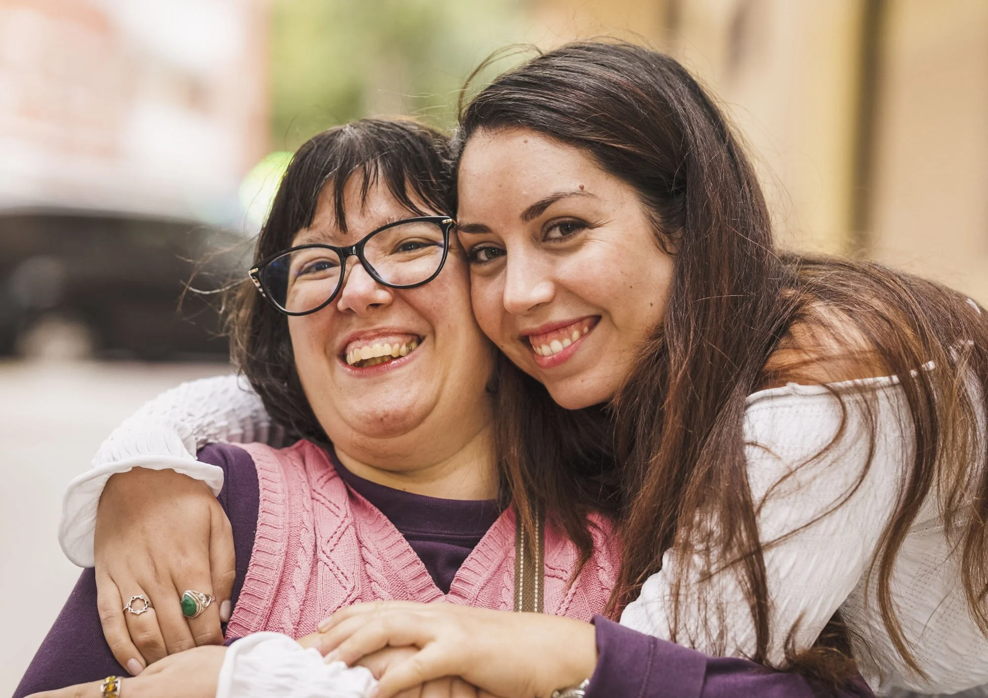 Two women sharing a supportive moment, representing confidence, connection and psychosocial recovery support.
