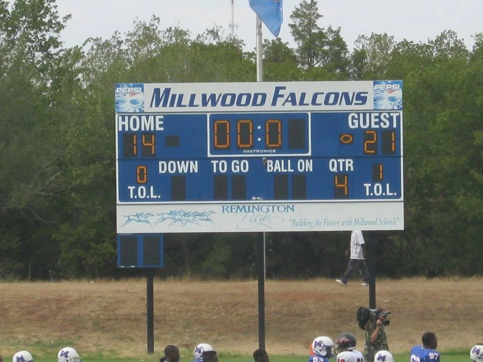 Scoreboard at a football game displaying 14 points for the home team and 21 points for the guest team, with a game clock at 0:00, and the teams' quarters and timeouts remaining.