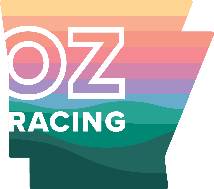 Logo for OZ Racing featuring rainbow-colored horizontal stripes and bold white text.