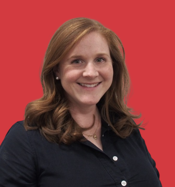 Woman with shoulder-length red hair smiling, wearing a dark collared shirt and pearl earrings, against a red background.