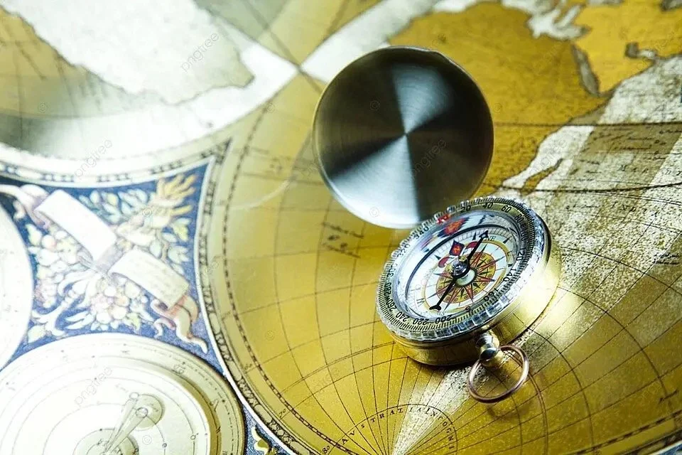 An open brass compass resting on an old, detailed world map.