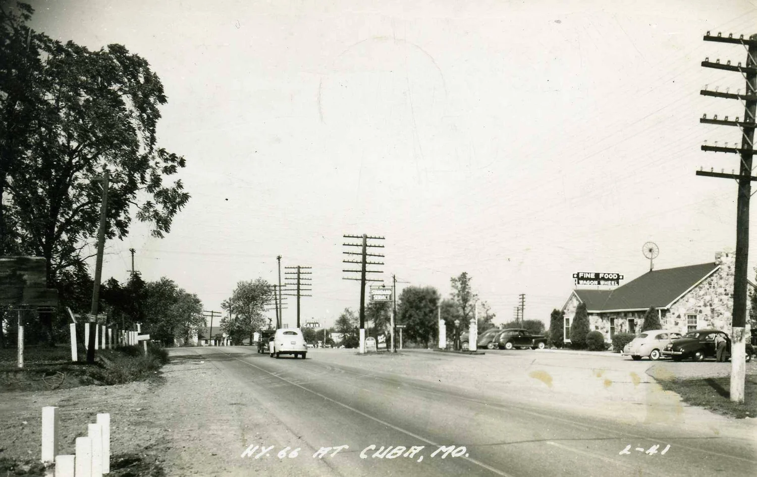 Historic black-and-white view of Route 66 beside the Wagon Wheel Motel in Cuba, Missouri