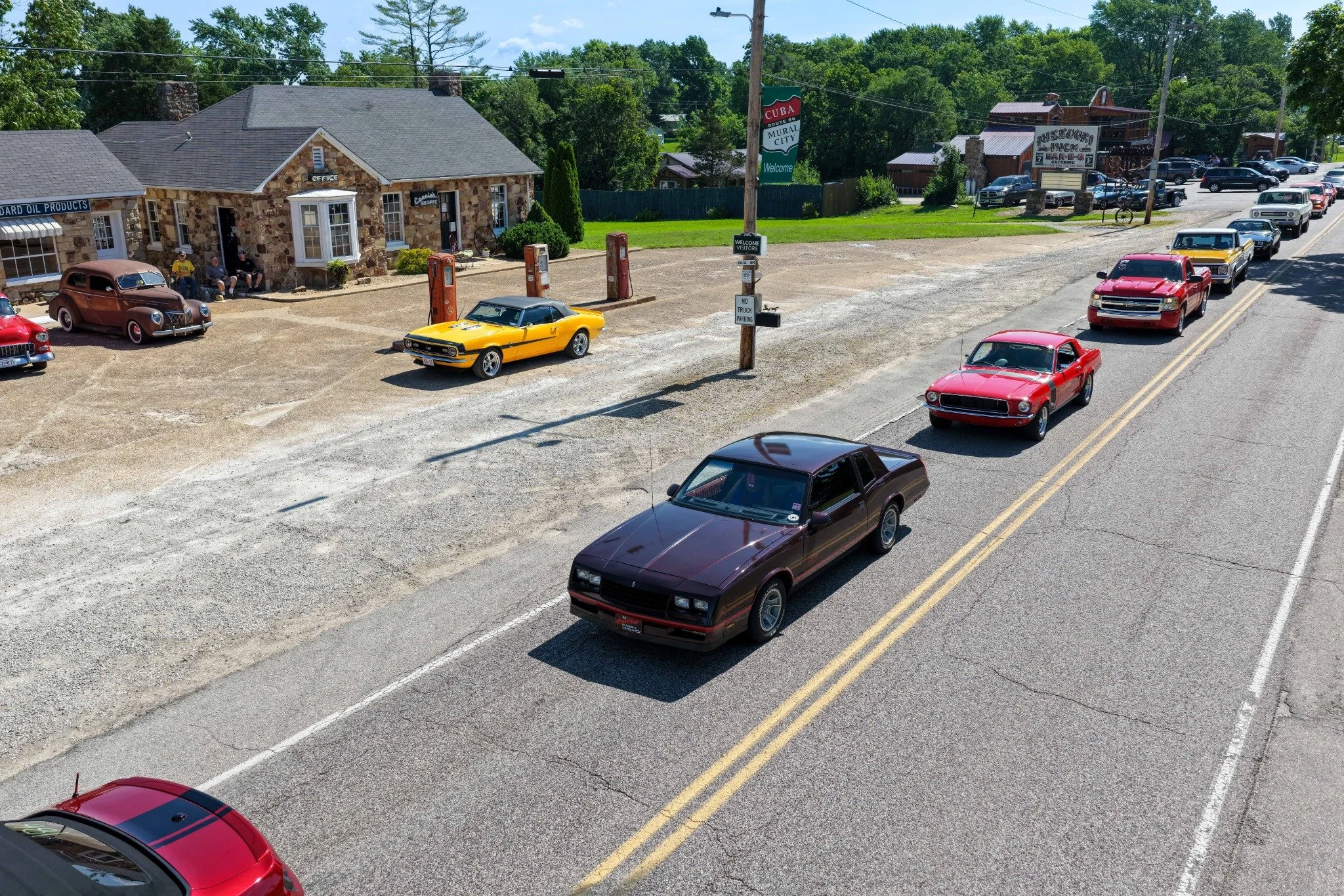 A Route 66 classic-car caravan passing the Wagon Wheel Motel in Cuba, Missouri.