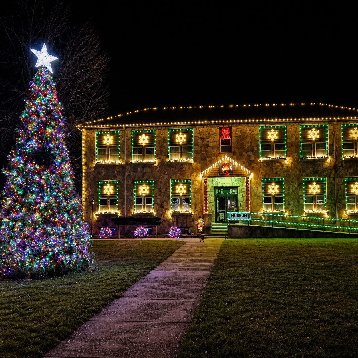 Illuminated Crawford County History Museum and Christmas tree in Cuba, Missouri.