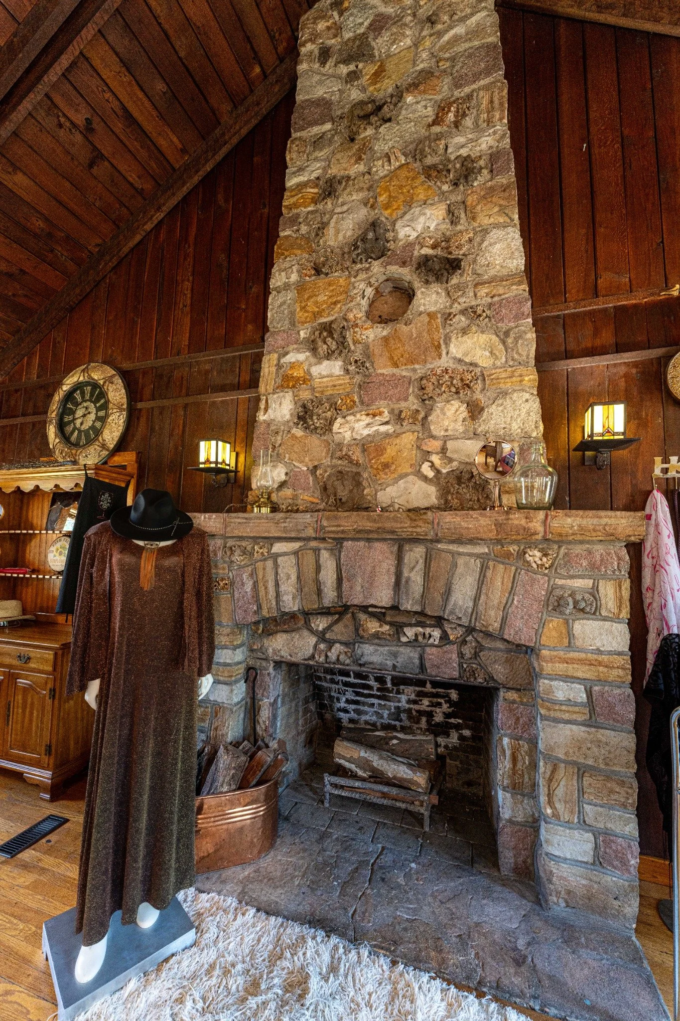 Original stone fireplace and rustic wood interior inside the Wagon Wheel Motel’s historic office building.