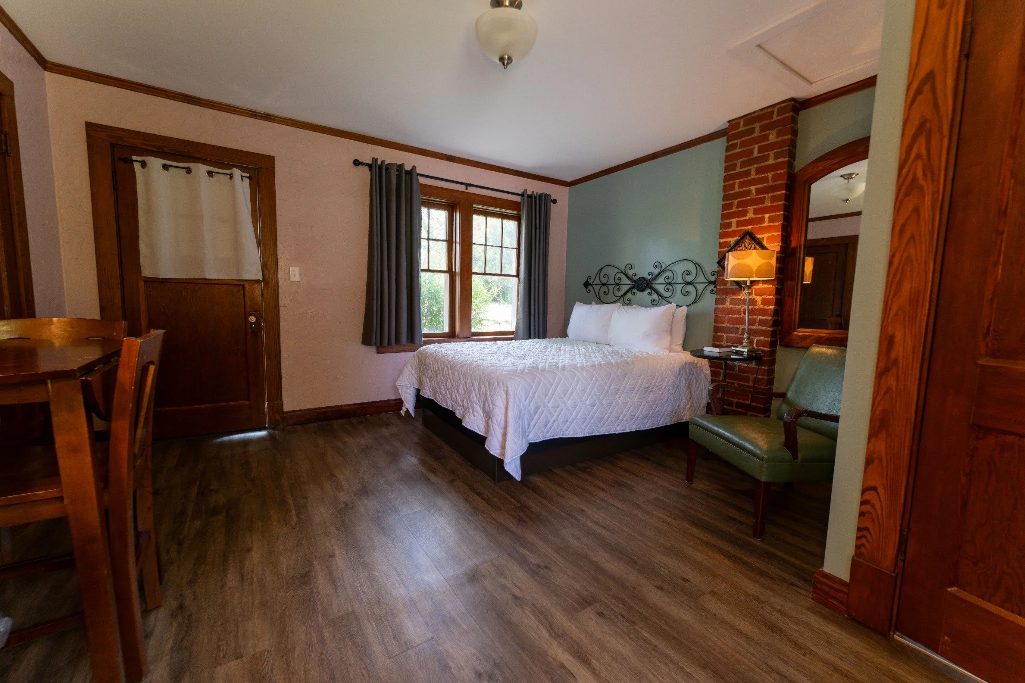 Historic guest room with a separate living area and original wood details at the Wagon Wheel Motel
