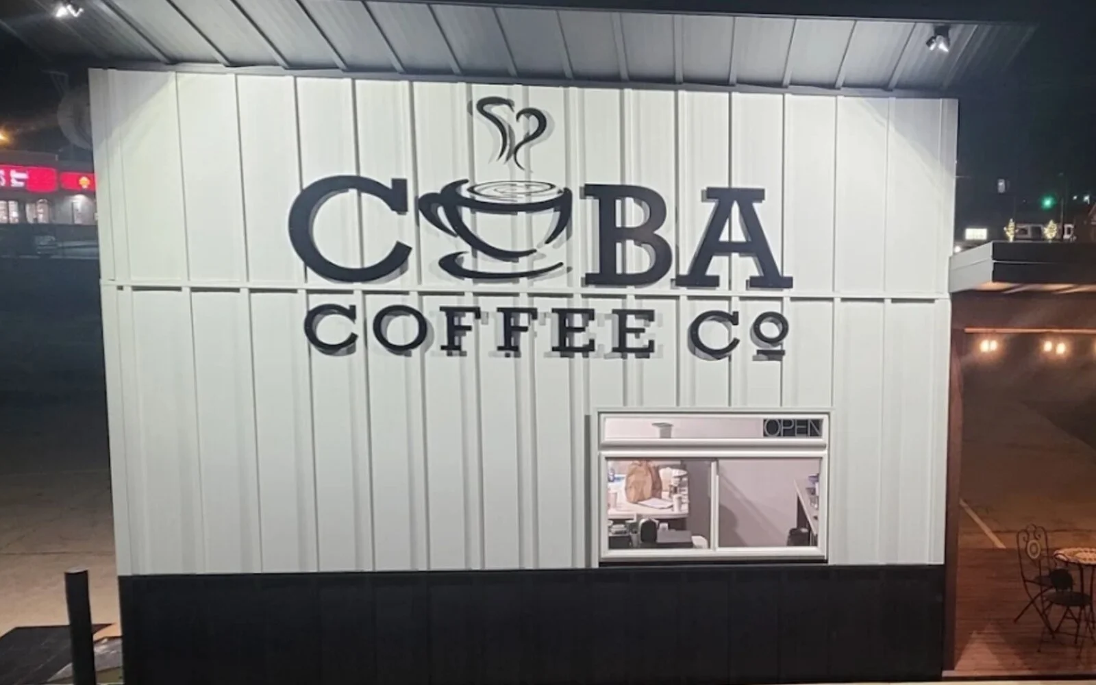Illuminated Cuba Coffee Company storefront in Cuba, Missouri.