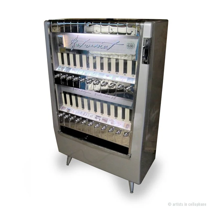 Vintage cigarette machine refurbished to sell cigarette pack-sized pieces of artwork.