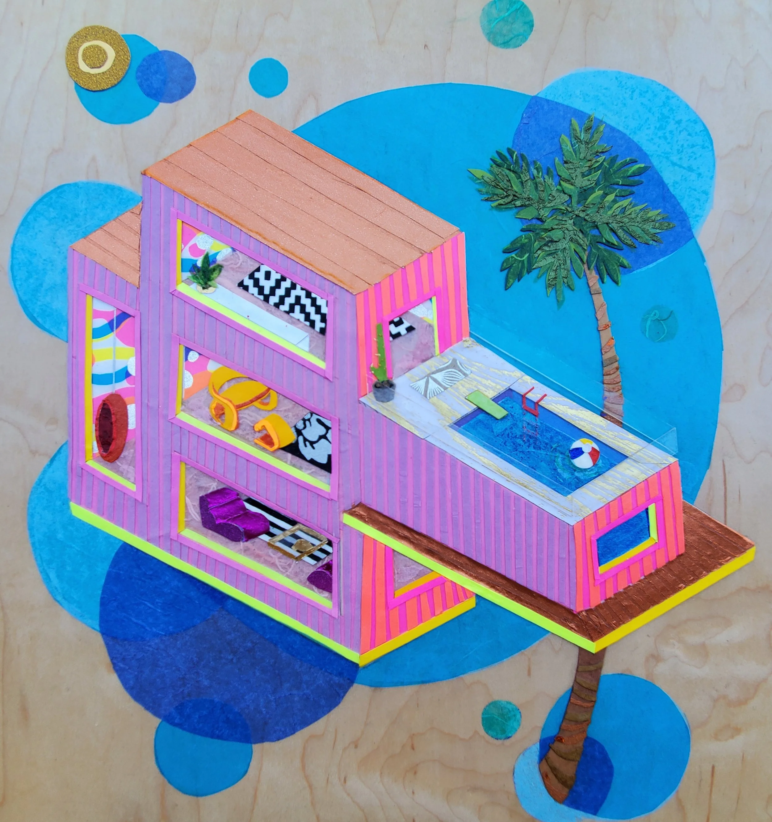 Colorful miniature dollhouse with pink walls, a swimming pool, and a palm tree on a wooden surface with blue circular accents.