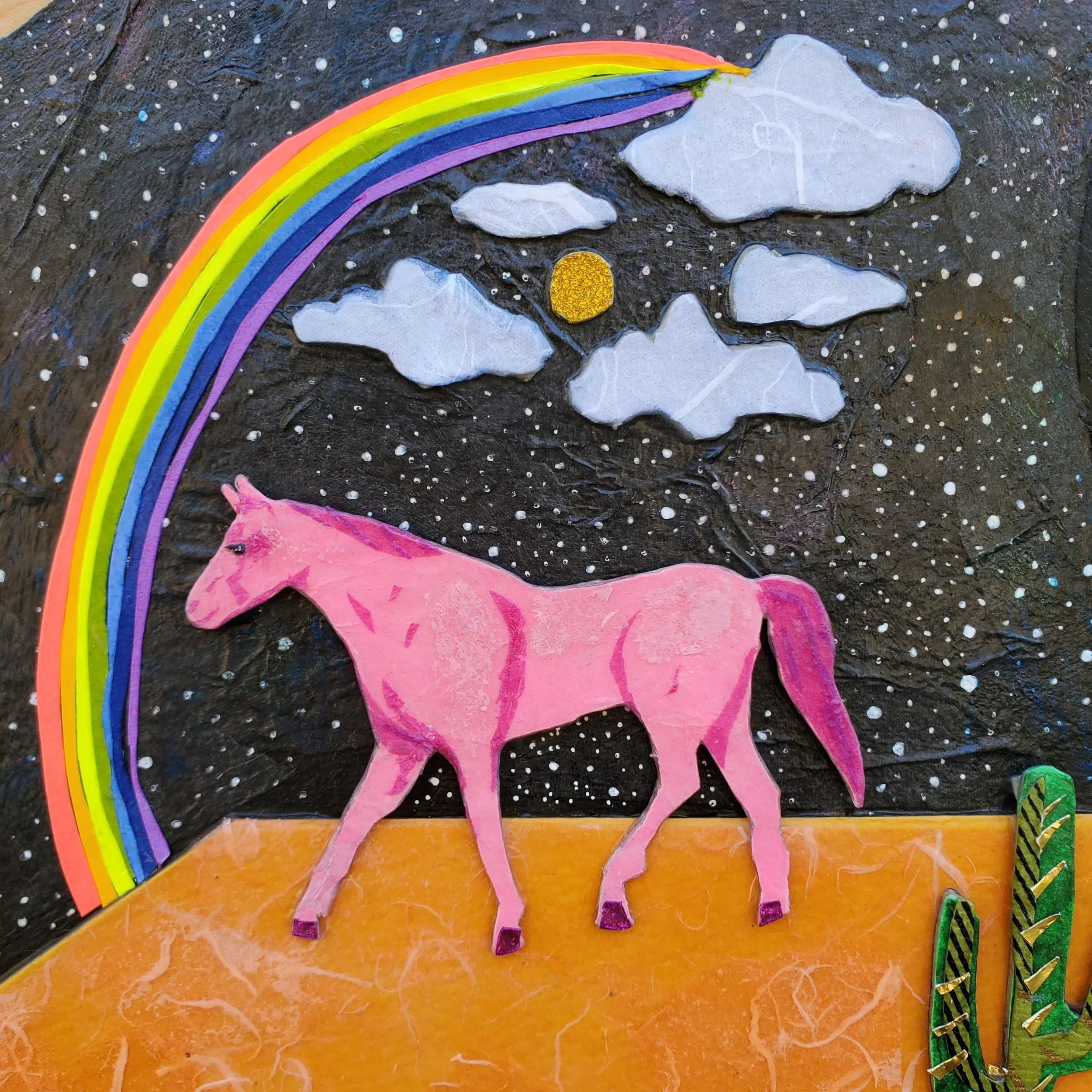 Colorful collage featuring a pink horse walking on an orange surface under a rainbow. The background depicts a starry night sky with white dots, clouds, and a yellow sun or moon.