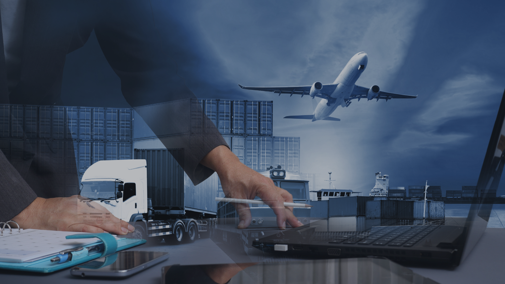 A person working at a desk with a tablet and notebook, with cargo containers and an airplane flying overhead at an airport.