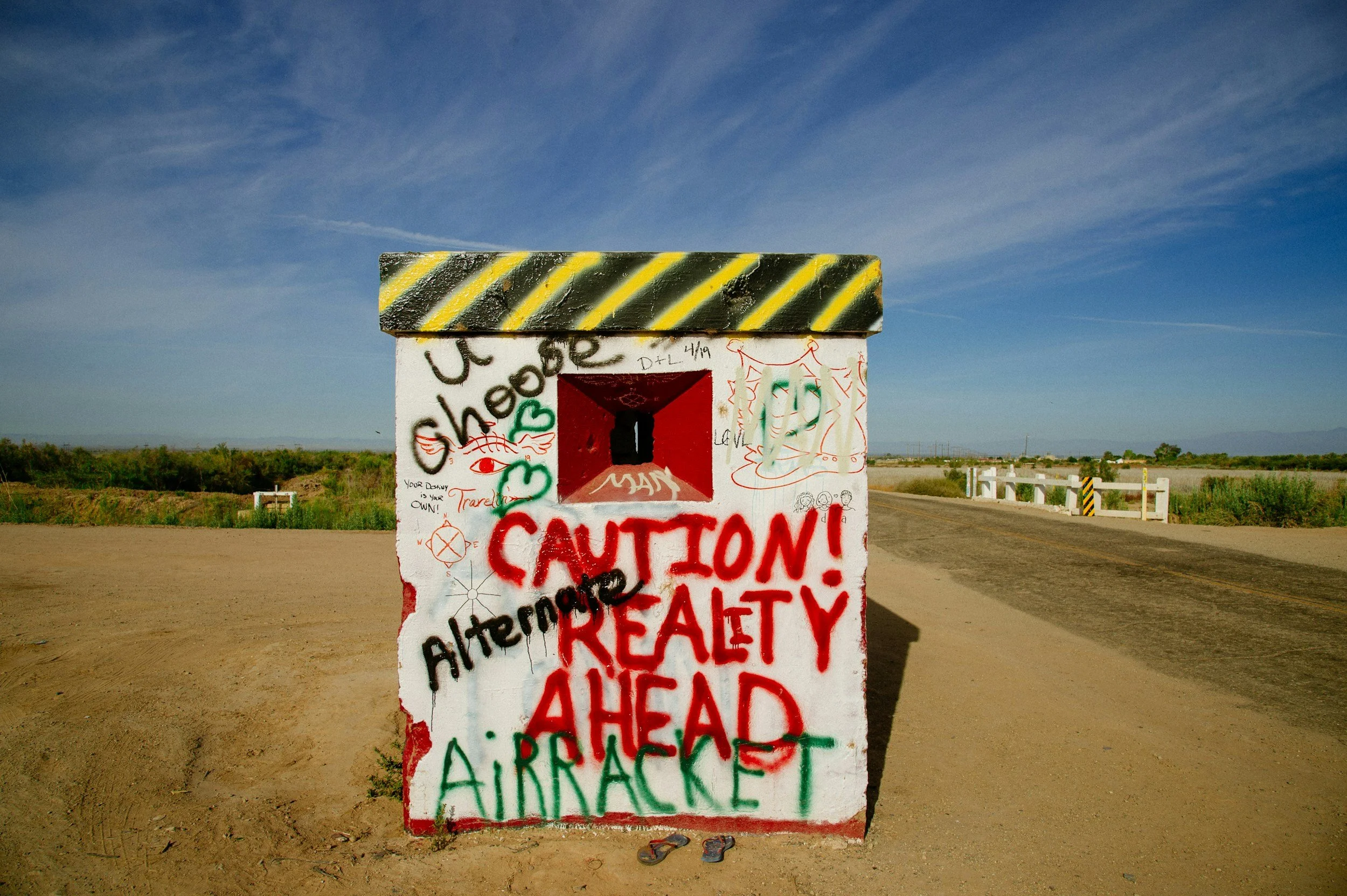 Caution Reality Ahead graffiti sign representing the gap between perceived and actual workplace culture