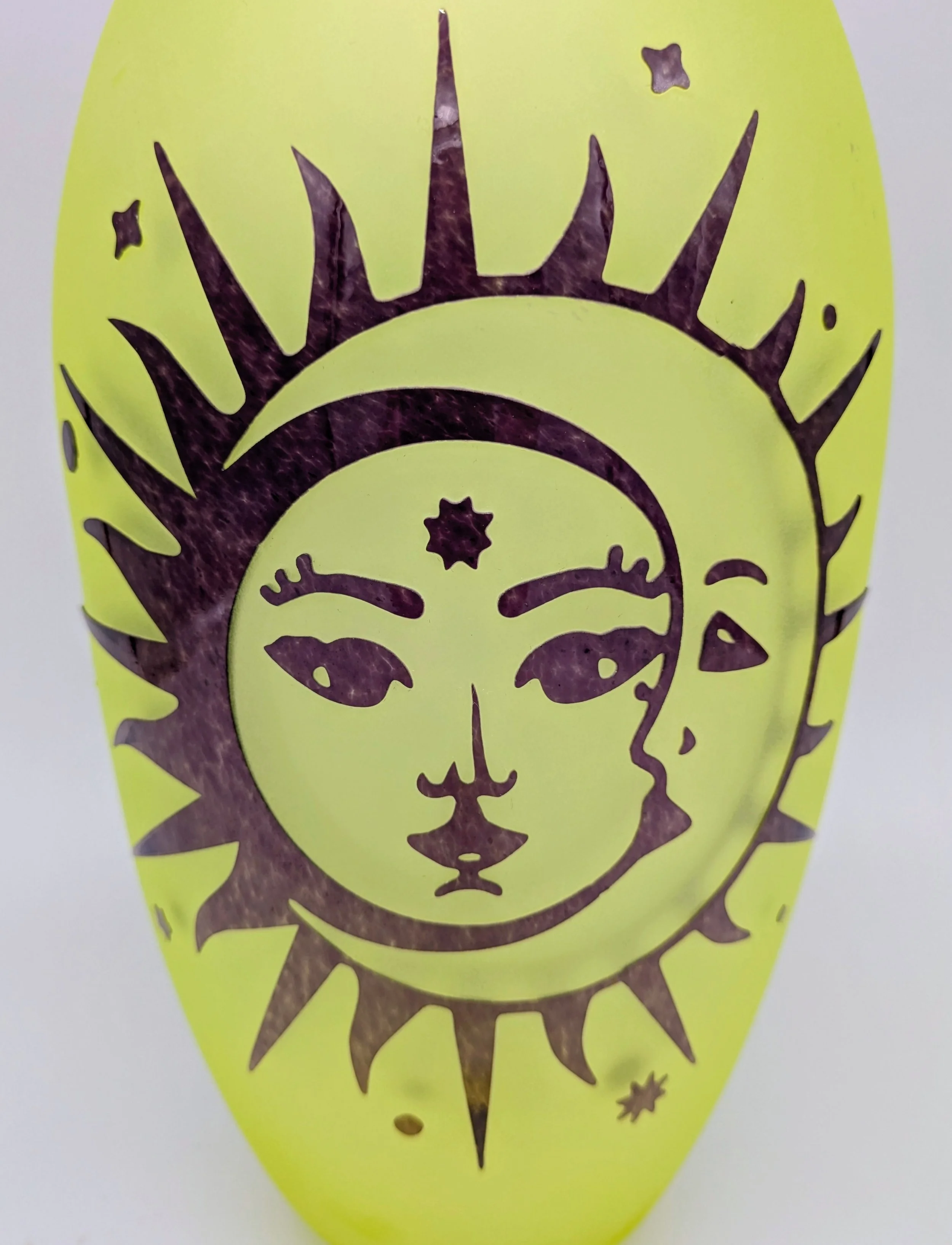 Uranium glass vase with sand carved pattern of the sun and moon.
