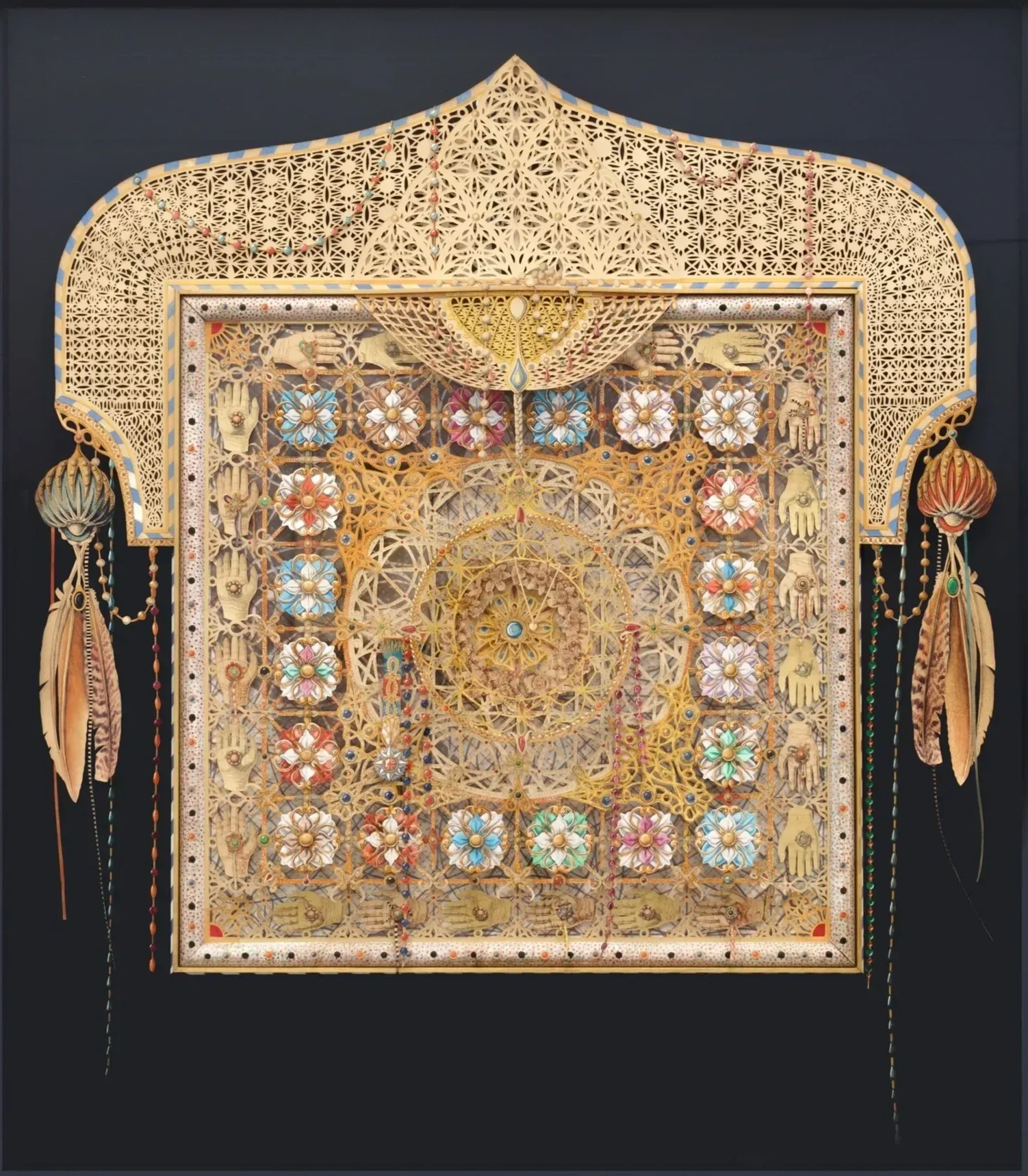 Intricate framed artwork by Carl Wilen with Iberian and spiritual design elements, including lace-like patterns, flowers, hand, and feather motifs.