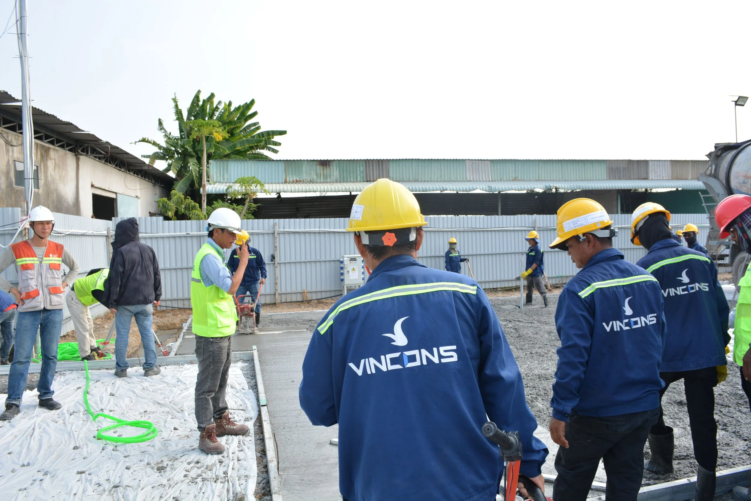 Construction crew in hard hats on a building site - safety by Z3 Collective