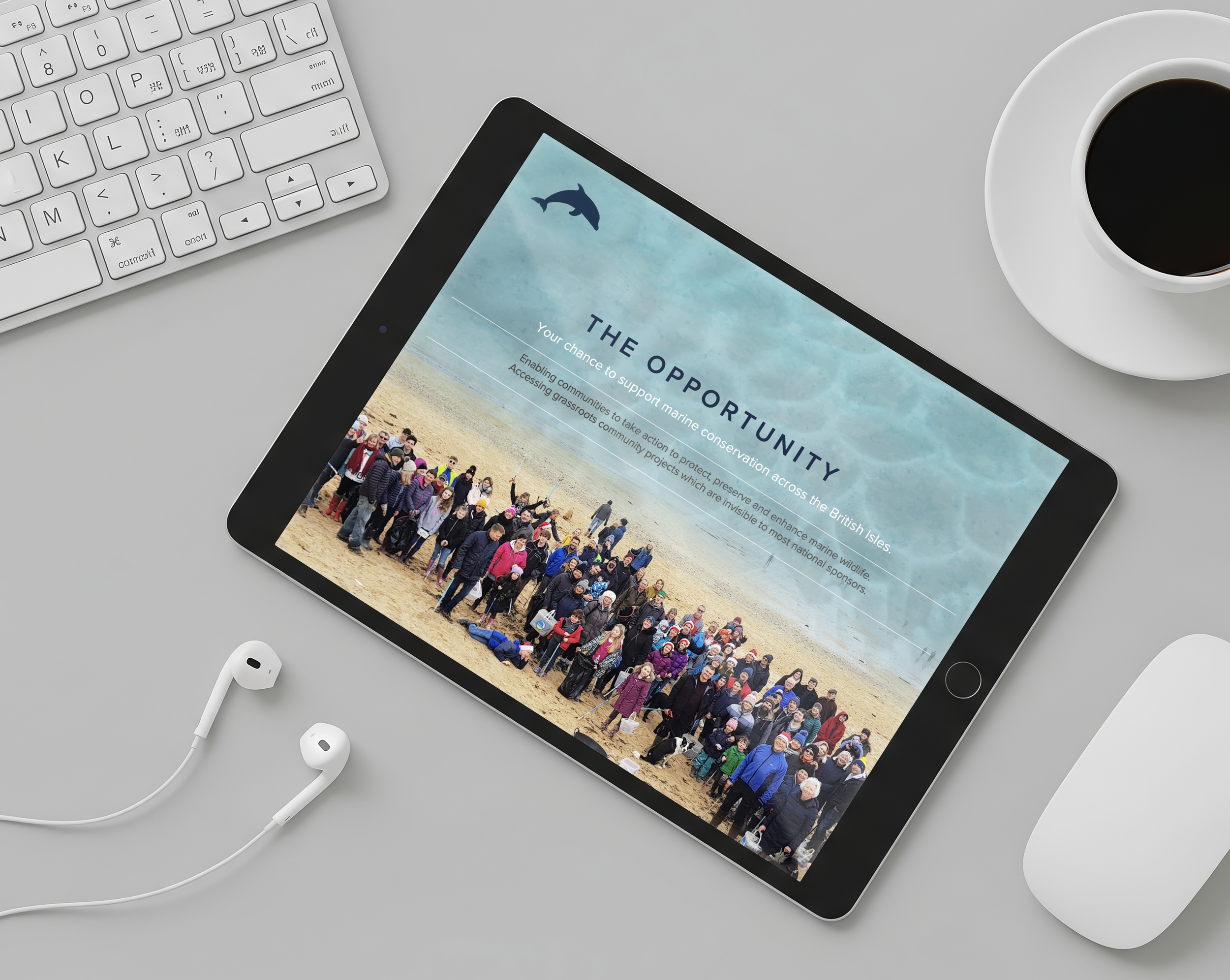 An iPad displaying a presentation titled 'The Opportunity' with a group photo of people gathered on a beach, with a whale icon and text about marine conservation across the British Isles.