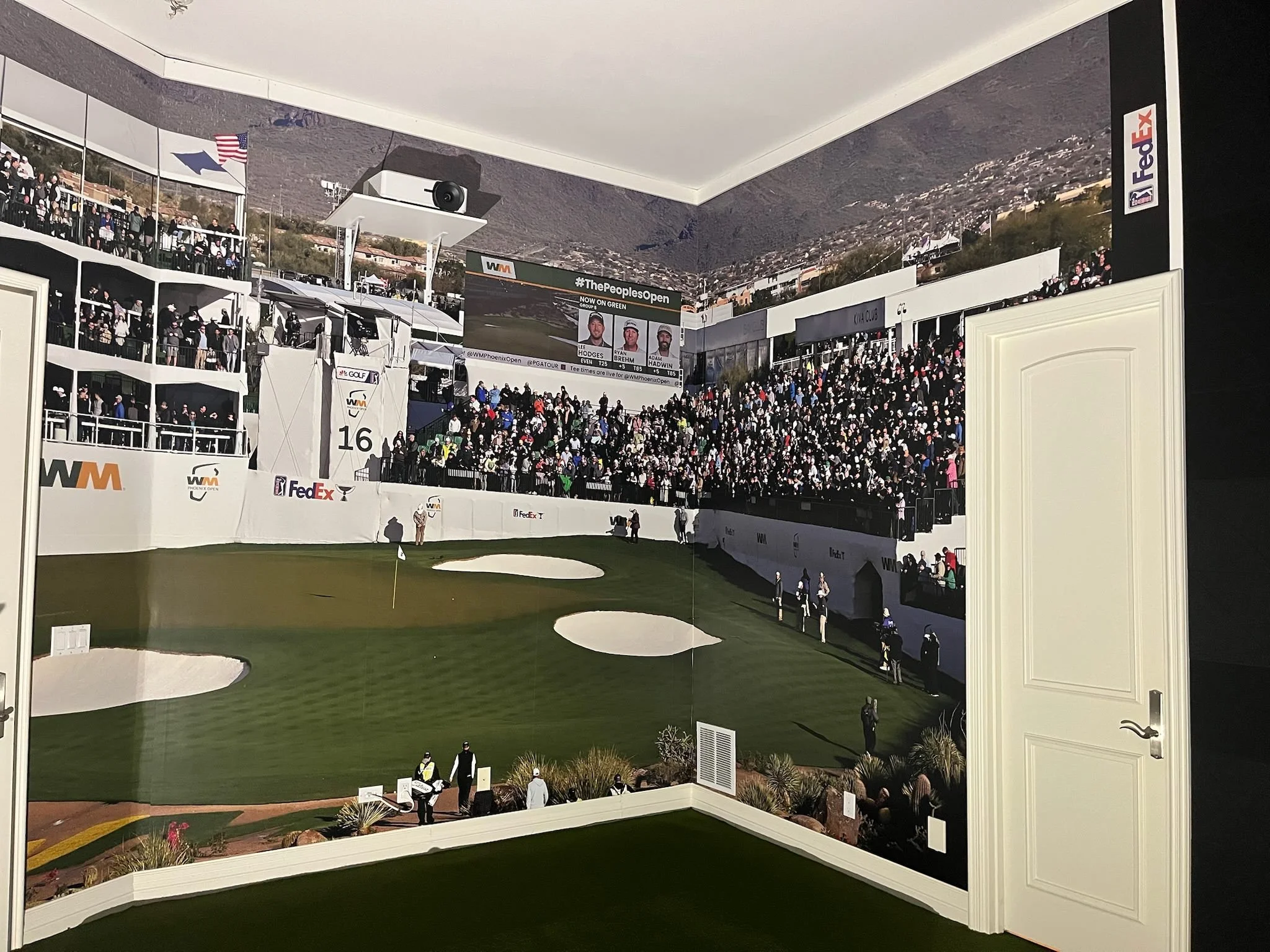 Photo of a mural depicting a golf tournament, with grandstands full of spectators, players, and event signage in an indoor setting.