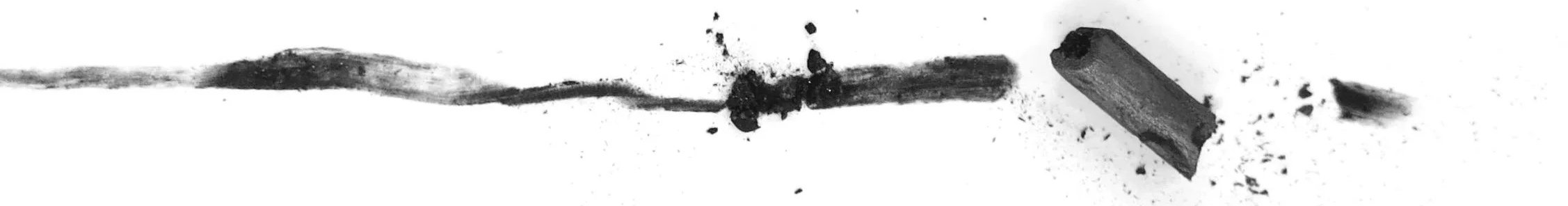 Black marks of willow charcoal stroke with breaks and smudges
