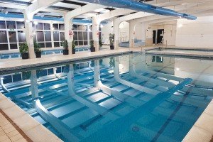 Indoor swimming pool with diving boards and large windows