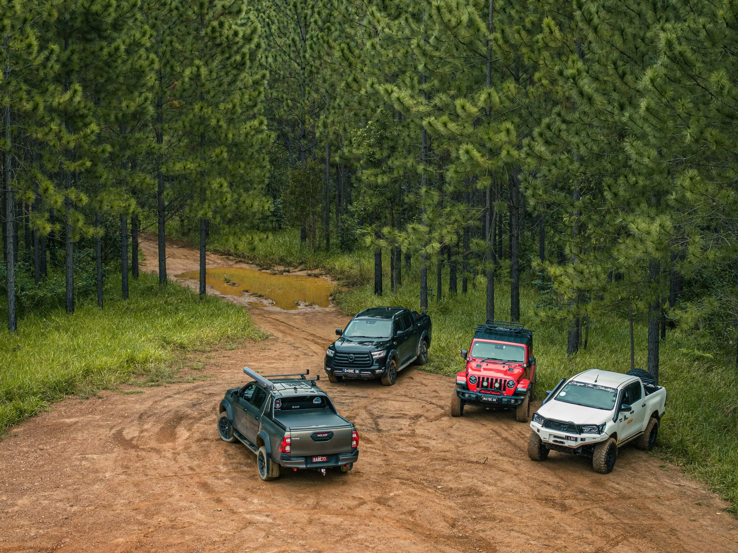 Four wheel drive vehicles parked on dirt trail Perth hills Western Australia