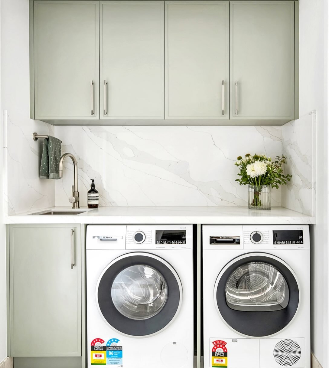Greenwich House | Laundry Design 

Practical spaces deserve thoughtful design too

Soft green cabinetry, clean stone surfaces and clever stone surfaces and clever storage create a laundry that&rsquo;s both functional and beautifully connected to the 