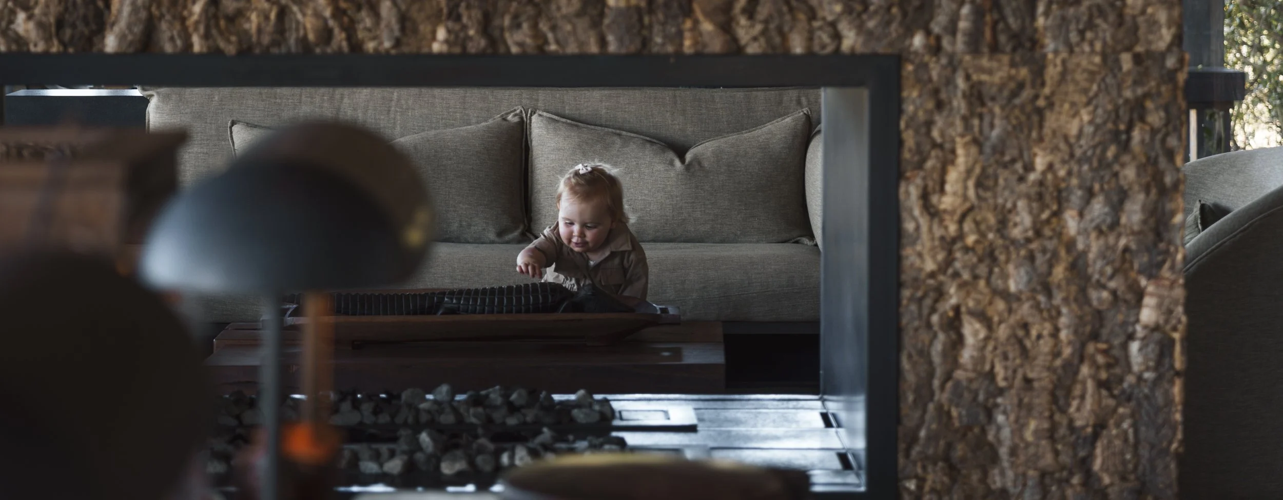 Toddler playing in the lounge of a safari lodge suite
