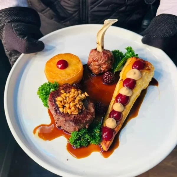 Event catering chef in Dorset holding plate of food