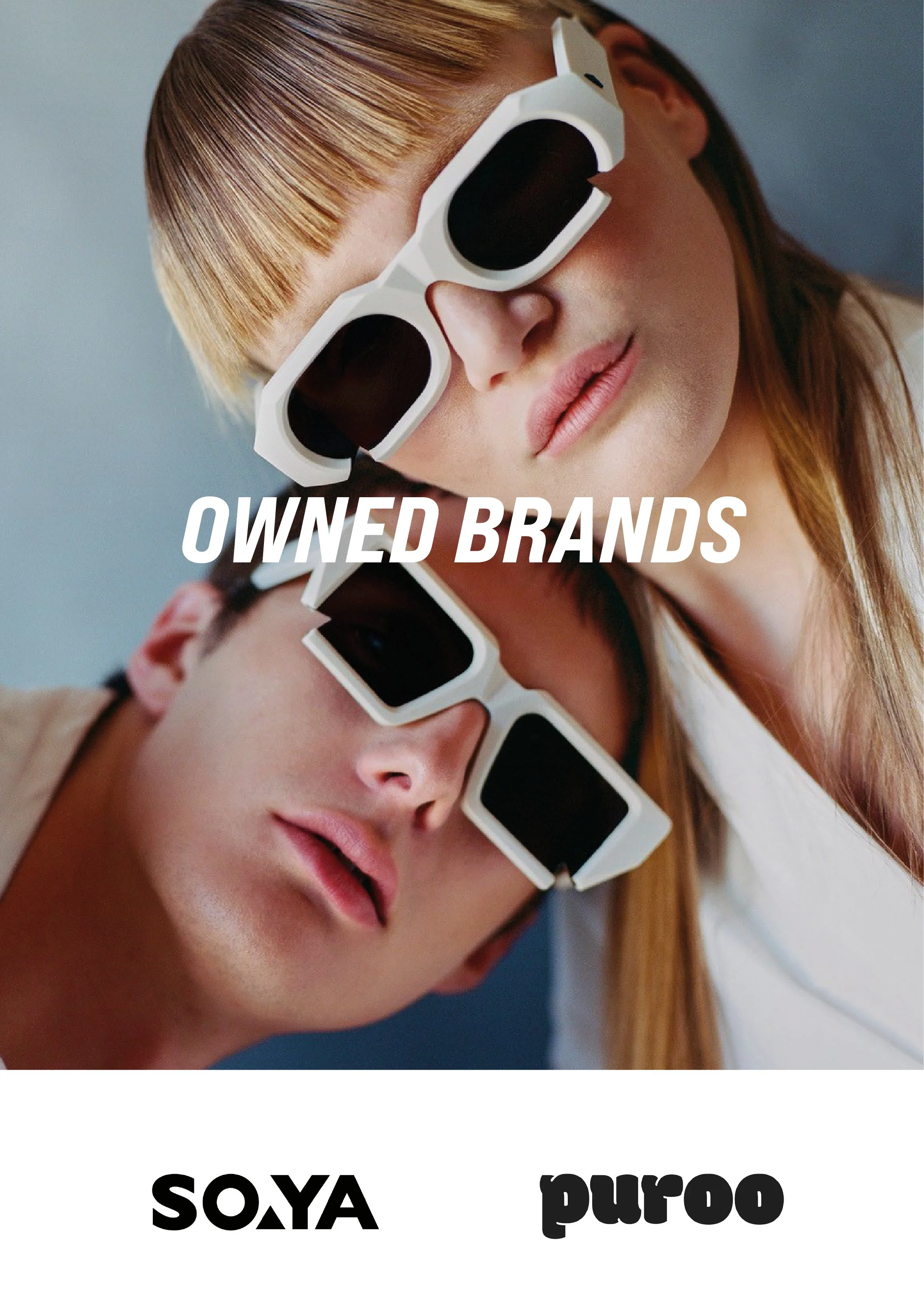 Close-up of two women wearing white sunglasses with dark lenses, one with light brown hair and the other with reddish hair, both with closed eyes and relaxed expressions.