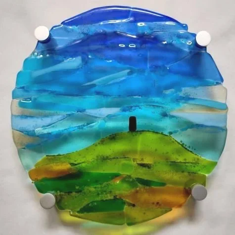 Circular fused glass picture of Glastonbury Tor