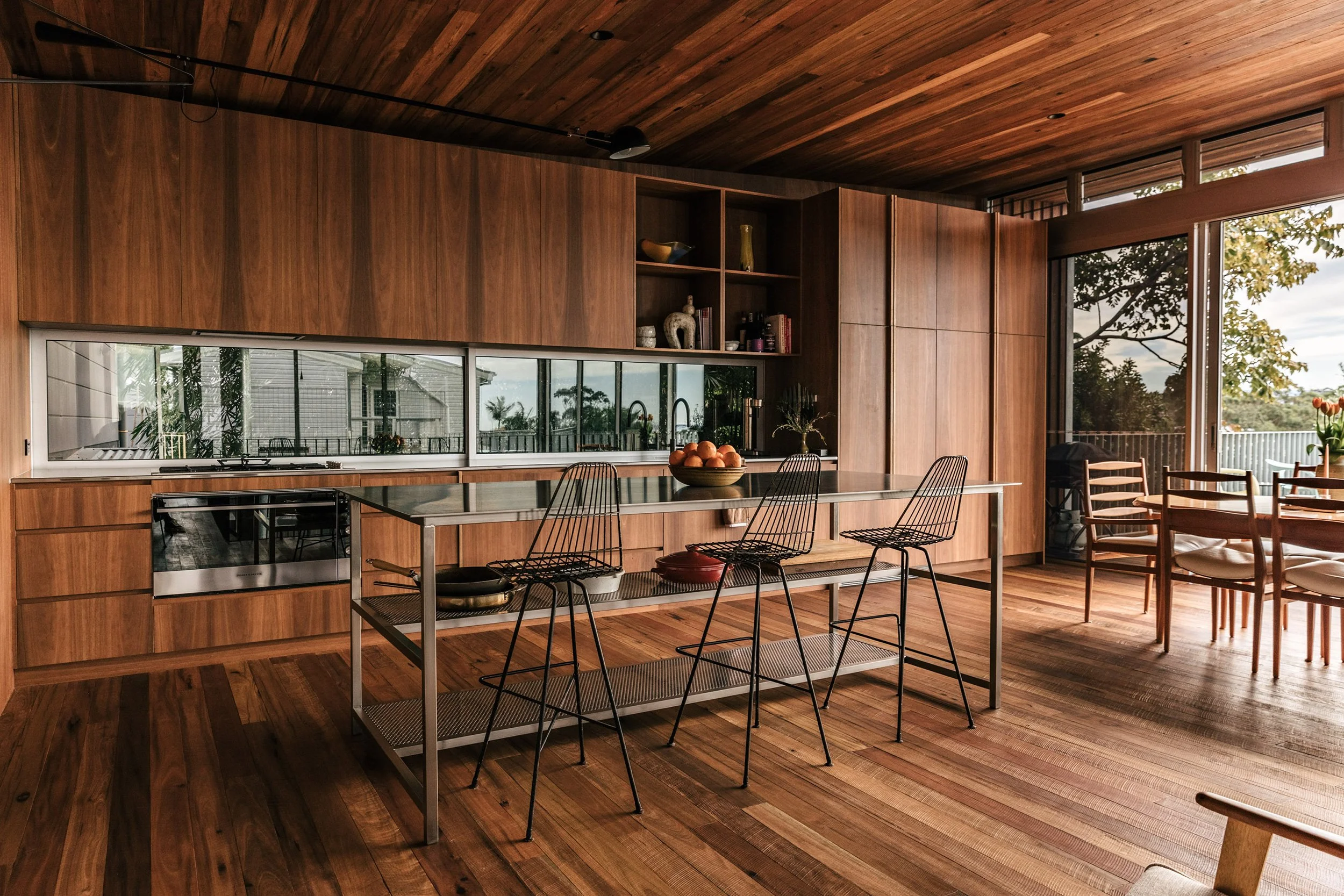 Timber filled open plan kitchen with minimal interior styling