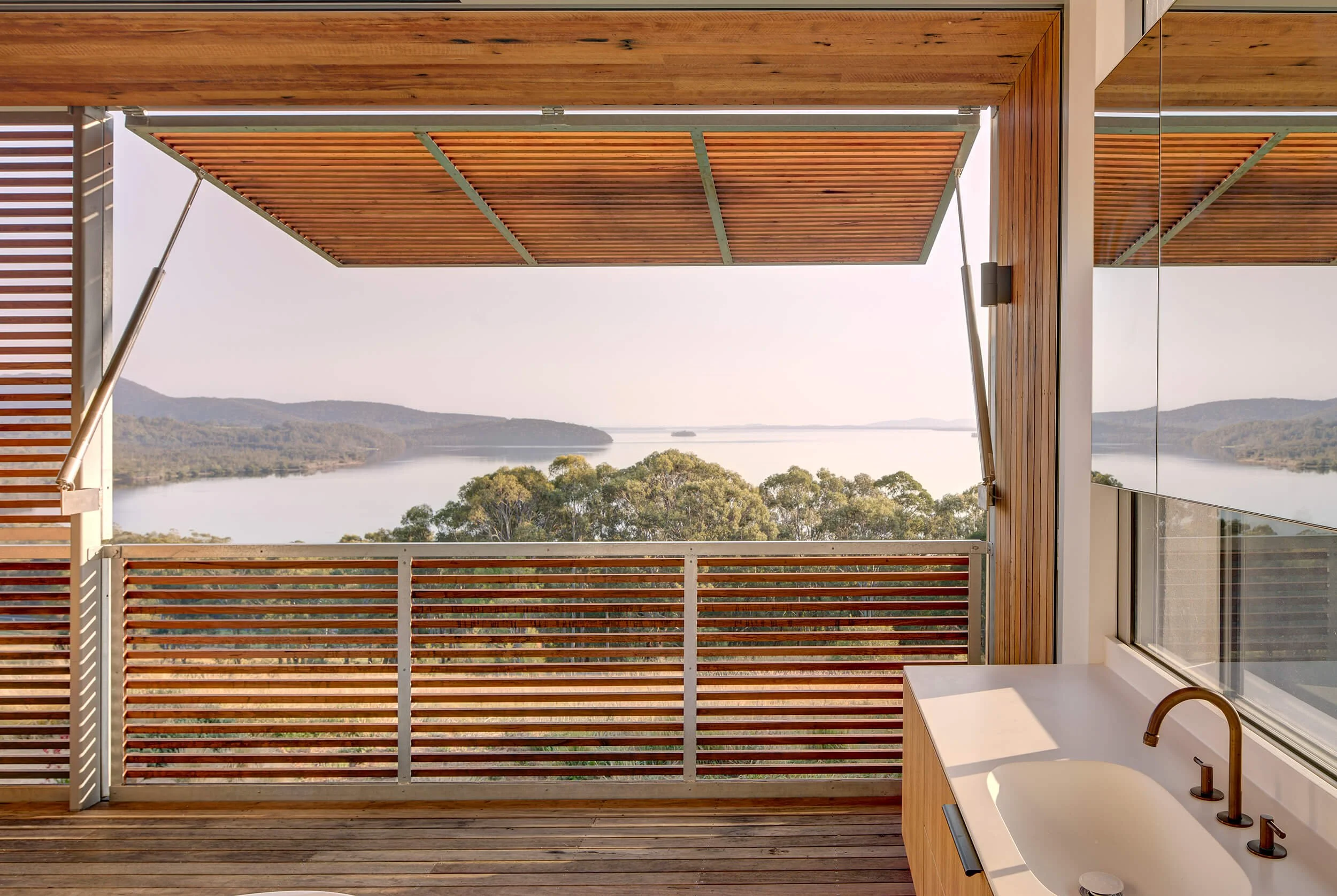 Coastal breeze-oriented architecture with forested mountain backdrop