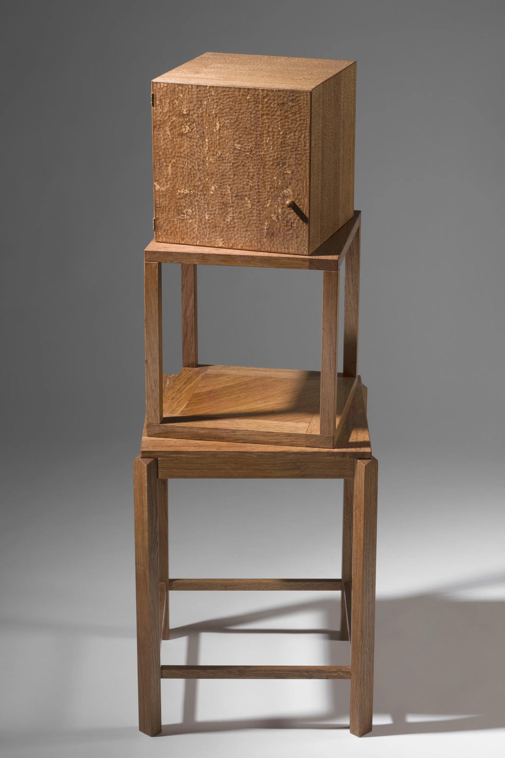 a small cabinet,  made of natural wood with visible grain and texture.