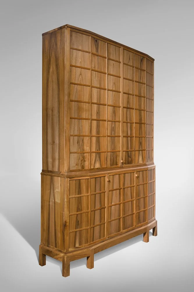 A tall wooden cabinet, featuring a grid pattern and a natural wood finish.