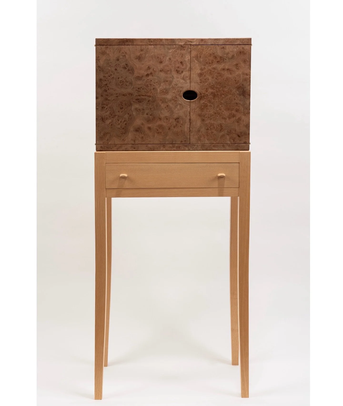 Elm &amp; Ash Cabinet

Crafted from Irish ash and burr elm, with white oak lining inside for a soft contrast. The burr elm came from a small, gifted piece of timber from a friend in Blessington, which I used to make saw-cut veneers, carefully arrange