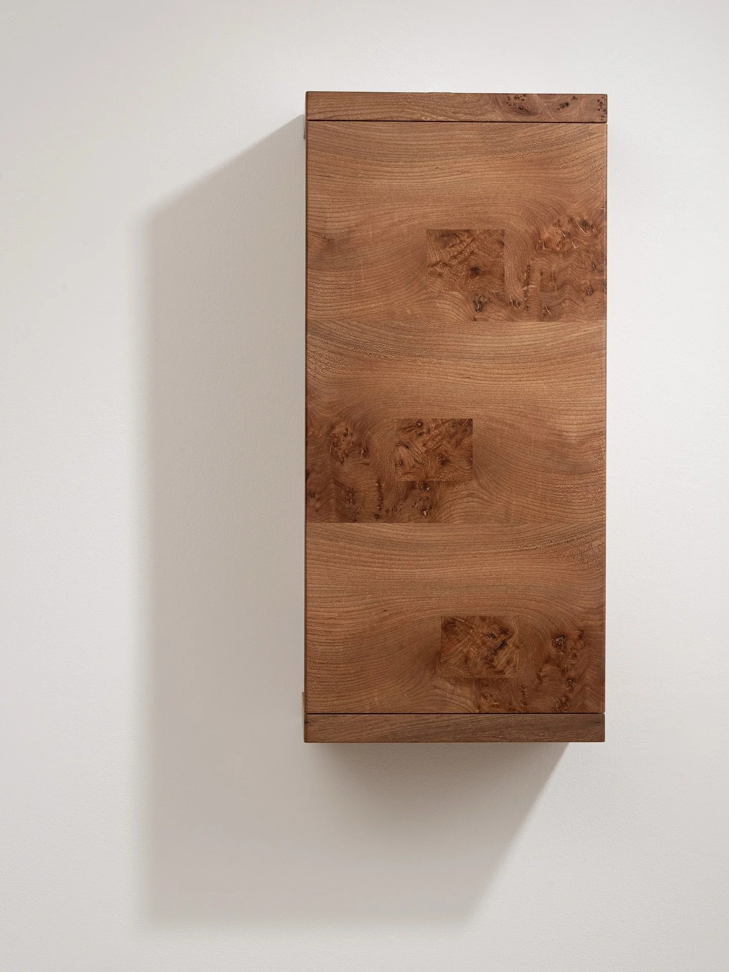 Made from wych elm sourced just five miles from my workshop, this cabinet uses parquetry techniques created with hand-cut veneers. I incorporated visible repairs and patches as part of the design, adding an element of honesty to my use of materials. 