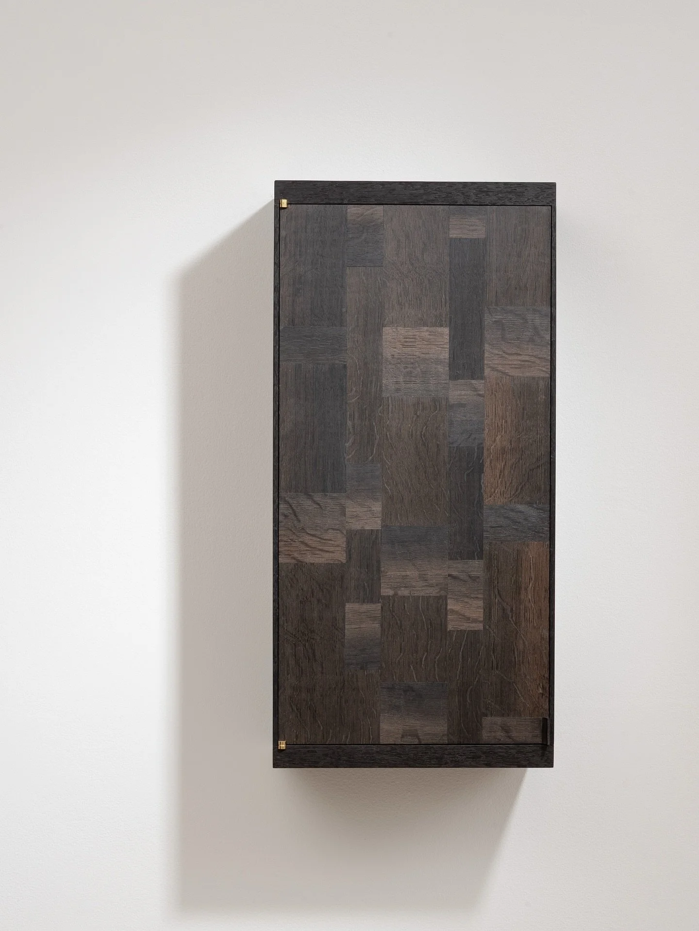 Bog Oak ParquetryCabinet.
Made from 5,000-year-old quarter-sawn bog oak, this cabinet highlights striking medullary rays and a subtle palette of tones
&mdash;deep blacks, warm browns, and hints of silver. The parquetry is created from carefully arran
