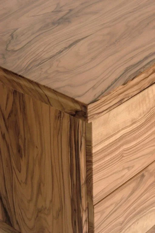 Close-up of a wooden corner with visible wood grain and grain patterns.